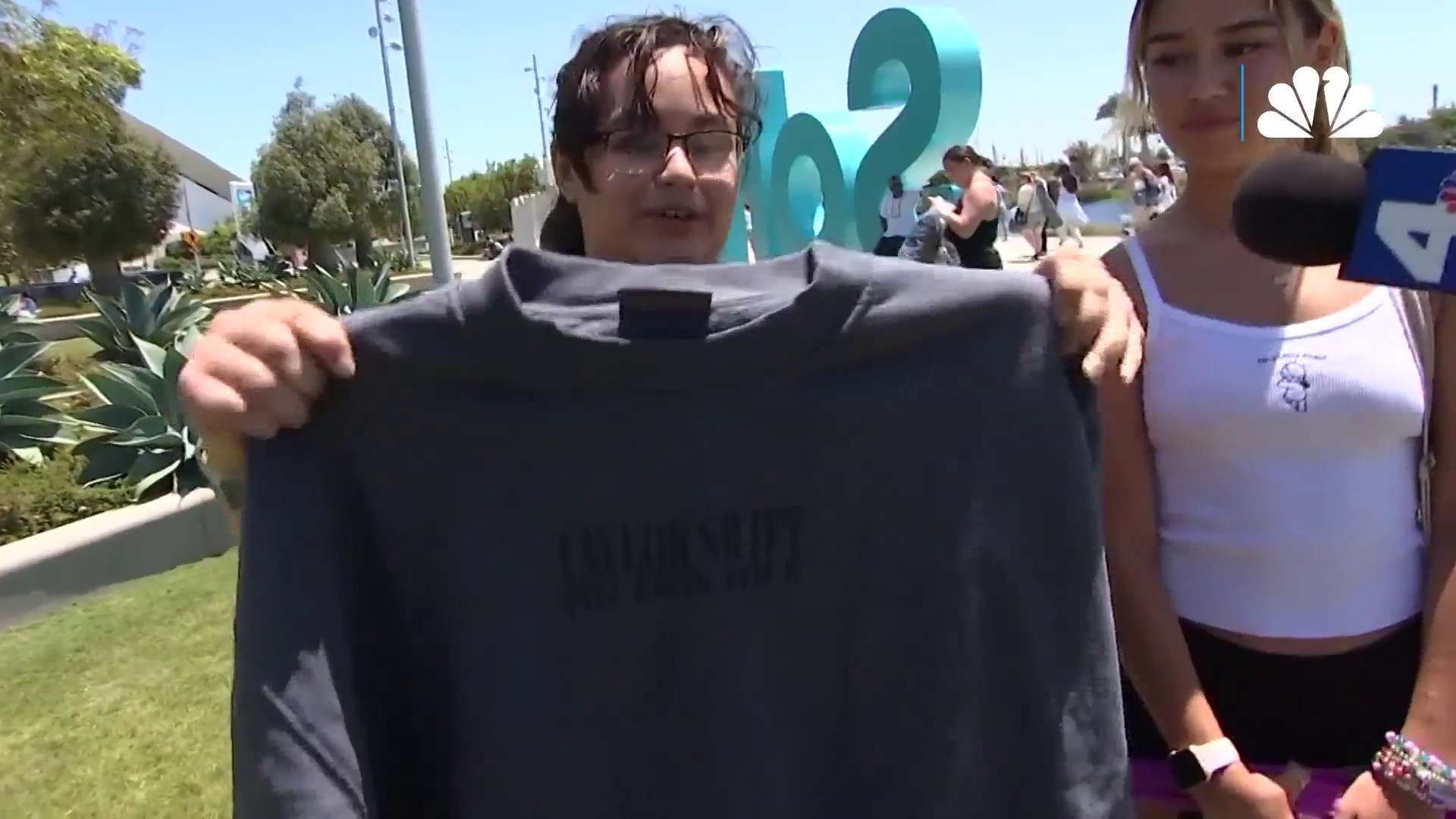 A fan shows off her new crewneck during Taylor Swift Early Merch Day in Inglewood Wednesday Aug. 2, 2023.