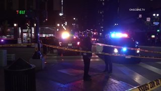 Picture of the scene showing police, police cars and caution tape near a 7-Eleven in Downtown San Diego