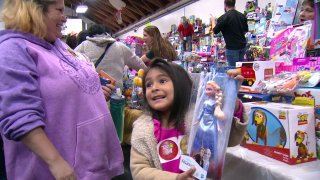 Little girl receiving her toys