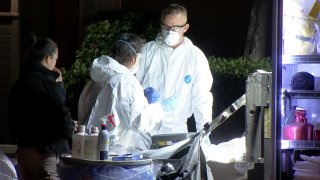 Hazmat investigators work to decontaminate a University City apartment unit where 1.5 million deadly doses of fentanyl were seized.
