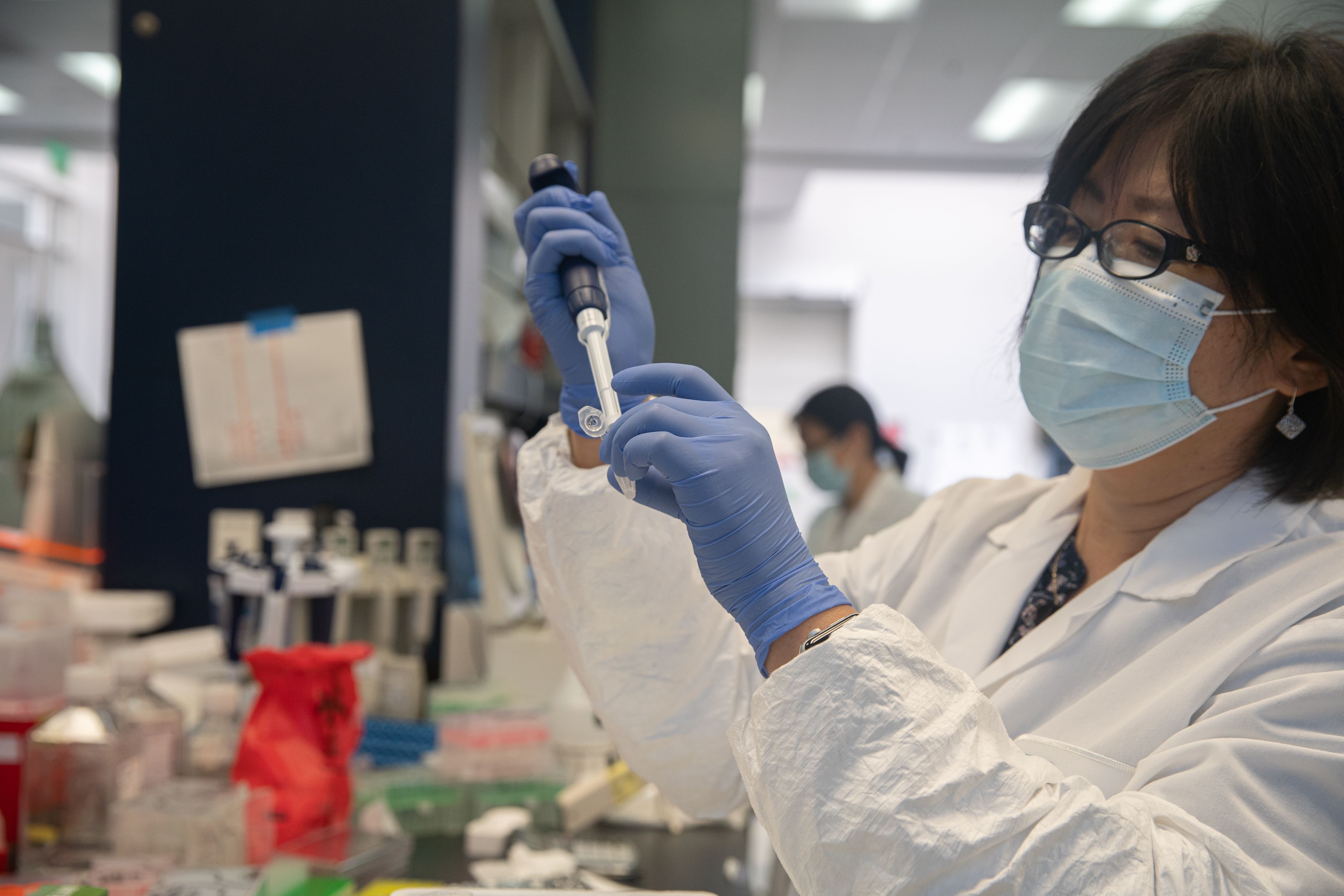 In this May 22, 2020, file photo, Bonghui Li works in a lab that is focused on fighting COVID-19 at Sorrento Therapeutics in San Diego, California.
