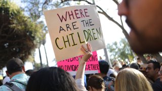A protester holds a sign at the 'Families Belong Together March' against the separation of children of immigrants from their families