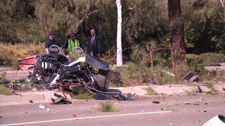 Investigators inspect car crash