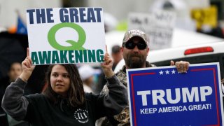 The Q-Anon conspiracy theorists hold signs during the protest at the State Capitol in Salem, Oregon, United States on May 2, 2020.