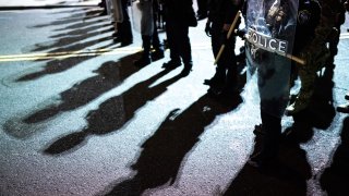 Federal officers line up prior to a crowd dispersal