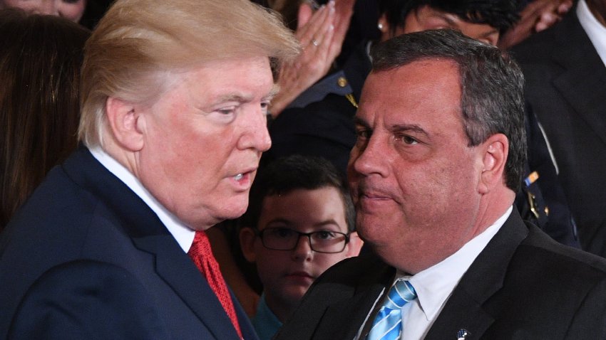 US President Donald Trump (L) speaks with Governor Chris Christie (R-NJ) after he delivered remarks on combatting drug demand and the opioid crisis on October 26, 2017 in the East Room of the White House in Washington, DC.