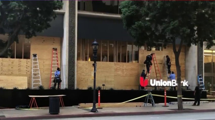 Workers boarding up windows at a Union Bank branch downtown on Nov. 2.