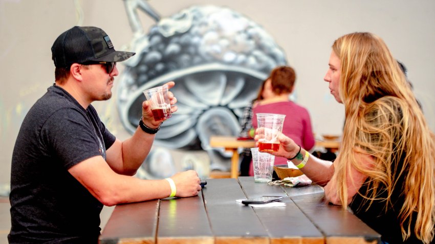 REDLANDS, CA – DECEMBER 05: Trevor Miller, left, enjoys a beer with Breann Puchalski while dinning outdoors at Ritual Brewing Co. in Redlands on Saturday, Dec. 5, 2020. As coronavirus cases surge at a record pace, California Gov. Gavin Newsom announced a new stay-at-home order.  Restaurants will shutdown dine-in services starting Dec. 6. (Photo by Watchara Phomicinda/MediaNews Group/The Press-Enterprise via Getty Images)