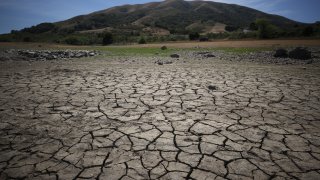 Dry cracked earth is visible as water levels are low at Nicasio Reservoir on May 28, 2021 in Nicasio, California.