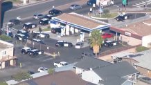 Law enforcement at an ARCO gas station in El Cajon, where a high-speed chase came to an end on Wednesday, Dec. 1, 2021.