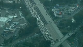 Traffic piles up in La Jolla on northbound I-5 after a body is found on the freeway on Thursday, Jan. 6, 2022.