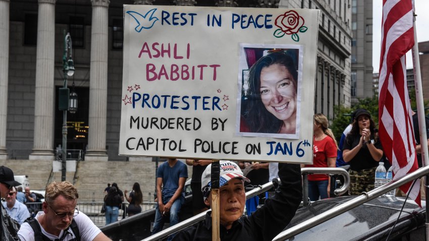 A right wing protester holds a sign about Ashli Babbitt while participating in a political rally on July 25, 2021 in New York City.