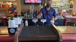 A server prepares drinks inside Casa Don Diego in Chula Vista, Jan. 23, 2022.