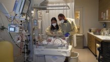 New parents Yumi and Stanislav “Stas” Cho lovingly look at their newborn daughter, Ella, at the Jacobs Medical Center at UC San Diego Health.