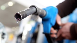 In this photo illustration a man refuels his car