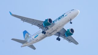 A Frontier Airlines aircraft flying over Gloster City, N.J., approaches Philadelphia International Airport Friday, Oct. 22, 2021.