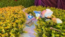 An Alice figurine rests near a stuffed animal duck, a stuffed animal fox and a vial of seeds as part of a riddle participants of The Alice - An Immersive Cocktail Experience could participate in.