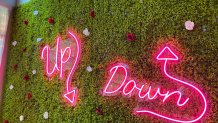 A neon sign reading "Up, Down" sets the tone for a topsy-turvy experience at this cocktail pop-up.