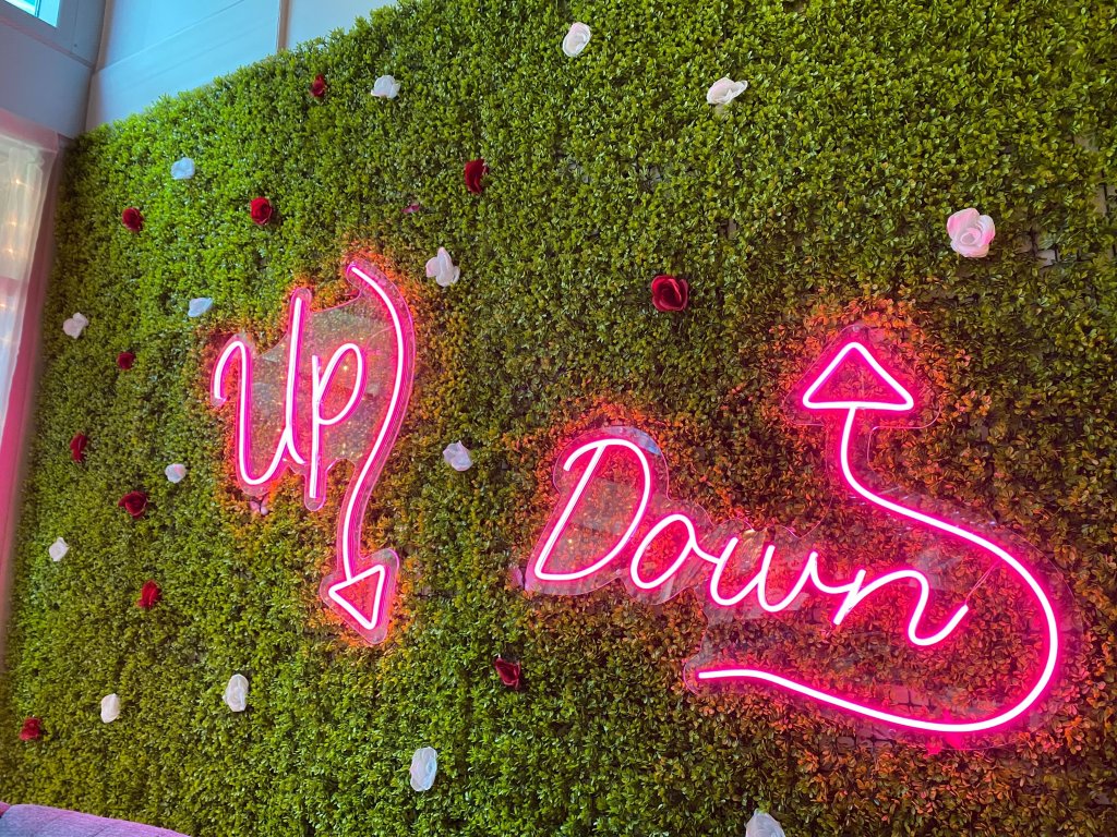 A neon sign reading "Up, Down" sets the tone for a topsy-turvy experience at this cocktail pop-up.