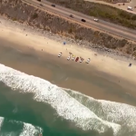 Rescue crews search for a possible missing swimmer off Torrey Pines State Beach, June 21, 2022.
