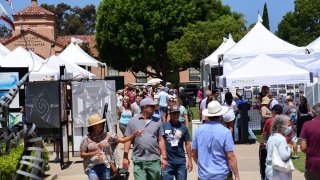 Visitors browse through various works of art at ArtWalk @ Liberty Station in 2021.