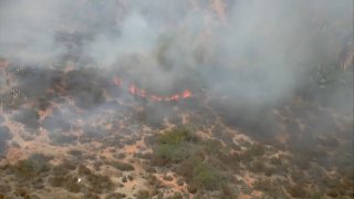 A small brush fire started near the SR-54/SR-125 interchange in Bonita on Wednesday, July 13, 2022.