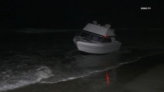 A boat with about 15 to 20 people on board washed ashore in Oceanside late Sunday, July 3, 2022.