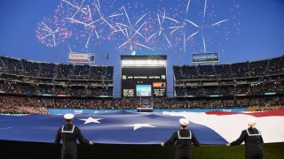 Fireworks in the sky over SDCCU Stadium and a large US Flag on the field before the start of the 2019 Holiday Bowl played on December 27, 2019 between the USC Trojans and the Iowa Hawkeyes at SDCCU Stadium in San Diego, CA.