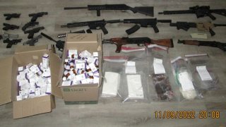 Some of the guns and drugs seized in the investigation.