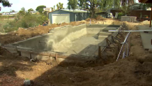 An unfinished pool in backyard