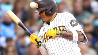 Manny Machado of the San Diego Padres is hit by a pitch on the hand during the second inning of a game against the Kansas City Royals at Petco Park on May 15.