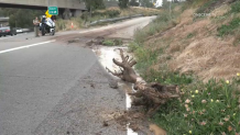 A mudslide on SR-163 which was caused by a sheared hydrant at the Hub shopping center above.