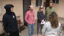 Investigative Reporter Alexis Rivas (right) speaks with three tenants in Ocean Beach whose leases are being discontinued and a local homeowner concerned about short term rentals.