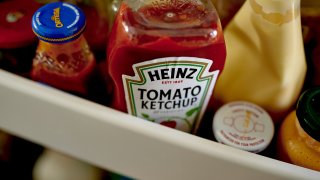 Heinz brand tomato ketchup arranged in the fridge.