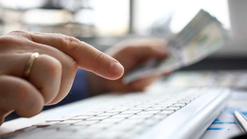 Male arms hold credit card press buttons making transfer closeup. Anti-fraud financial security when entering client discount program number or filling personal credential password login to account