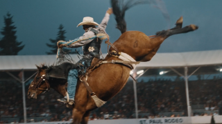 A rider hangs onto a bucking horse. (San Diego Padres)