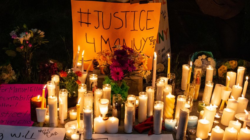 Candles and signs are seen during a vigil for Manuel Ellis, a black man whose March death while in Tacoma Police custody was recently found to be a homicide.