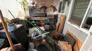 A resident's items covered in debris after flooding in San Diego's Southcrest neighborhood the day after a powerful storm system on Jan. 23, 2024.