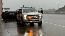 A vehicled flipped amid heavy rainfall on I-5 at Gennessee Ave. on Jan. 22, 2024.