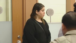 Woman wearing black in court.