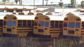 Parked buses at the San Diego Unified Transportation Department yard.