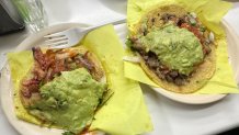 Adobada (izquierda) y carne asada (derecha) tacos cubiertos de guacamole en Tacos El Franco en Tijuana, México. (NBC 7 San Diego)