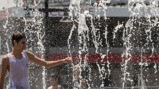 Un joven se refresca en una plaza en Nueva York el jueves.