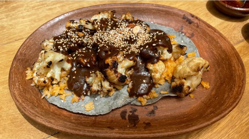 coliflor cubierta de mole sobre tortillas caseras en Carmelita Molino y Cocina. (NBC 7 San Diego)