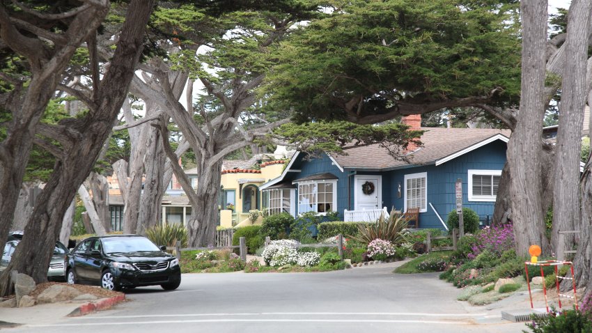 View of Street and walkway with  Cypress Tree and mansions on Carmel Beach in Carmel, California