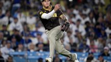 LOS ANGELES, CALIFORNIA - OCTOBER 06: Manny Machado #13 of the San Diego Padres throws to first base in the eighth inning against the Los Angeles Dodgers during Game Two of the Division Series at Dodger Stadium on October 06, 2024 in Los Angeles, California. (Photo by Orlando Ramirez/Getty Images)