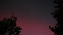 Reddish pink and purple hues streaked across San Diego County's skyline from a strong geomagnetic storm.