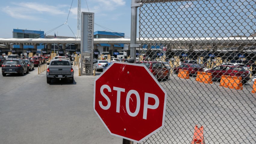 A fence blocks car lines at the San Ysidro crossing port on the US-Mexico border, as seen from Tijuana, Baja California State, Mexico, on June 4, 2024. The United States will temporarily close its Mexico border to asylum seekers from Wednesday, as President Joe Biden as tries to neutralize his political weakness on migration ahead of November’s election battle with Donald Trump. (Photo by Guillermo Arias / AFP) (Photo by GUILLERMO ARIAS/AFP via Getty Images)