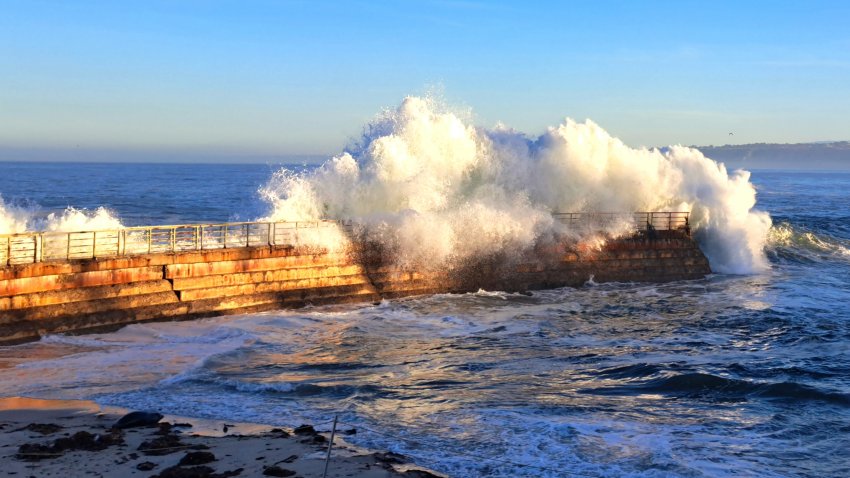 A wave crashes onto a railing at the Children's Pool in La Jolla (Barry Alman).