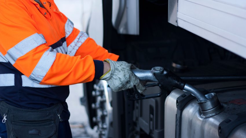 Man refueling diesel on big rig truck, truck driver refueling, global warming, pollution, fossil fuel,